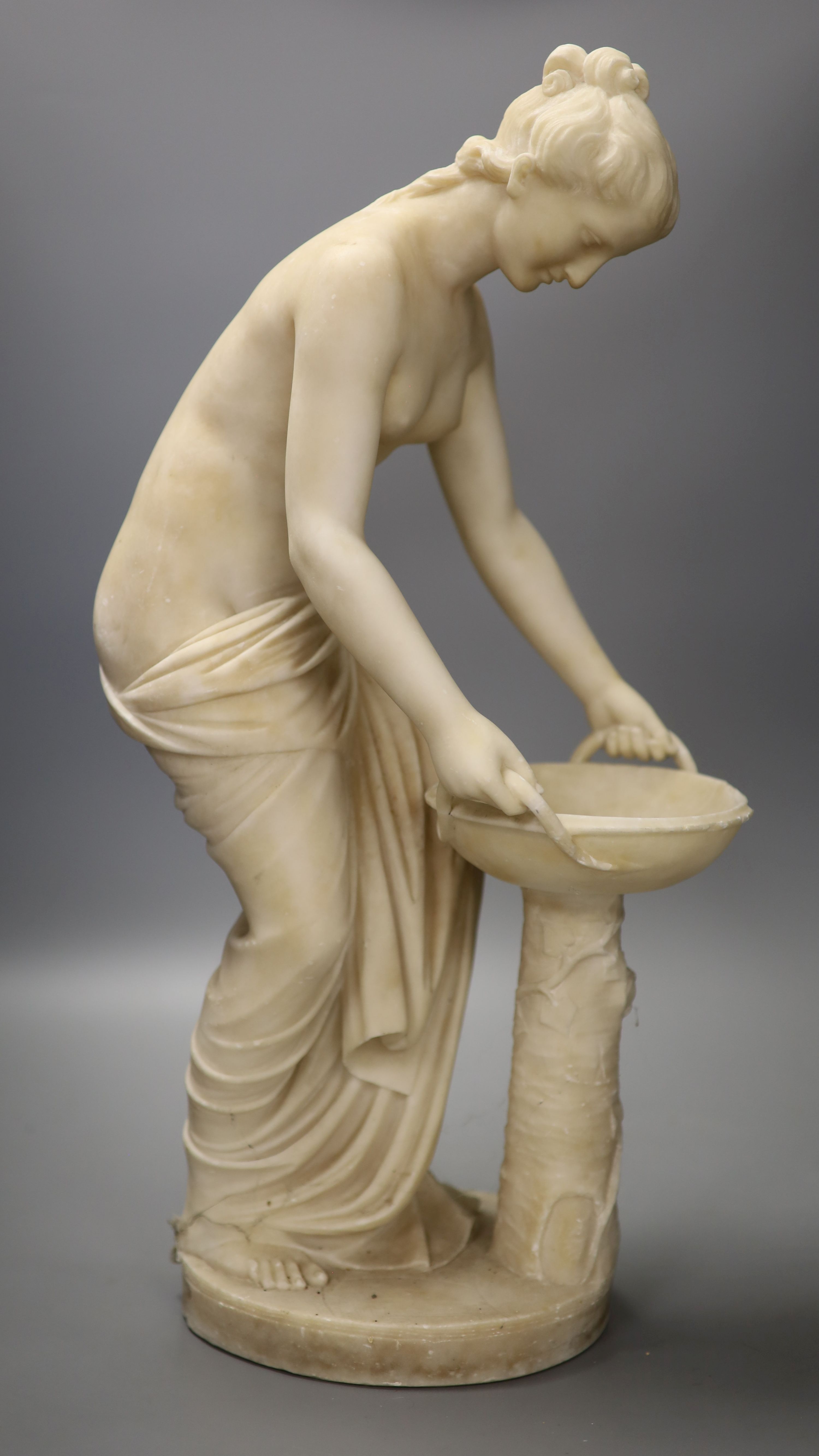 A classical alabaster figure of a water carrier, height 52.5cm